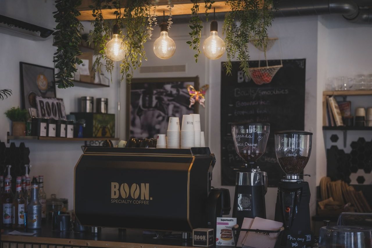 Cozy cafe with modern barista setup and lush decor in Almere, Netherlands.